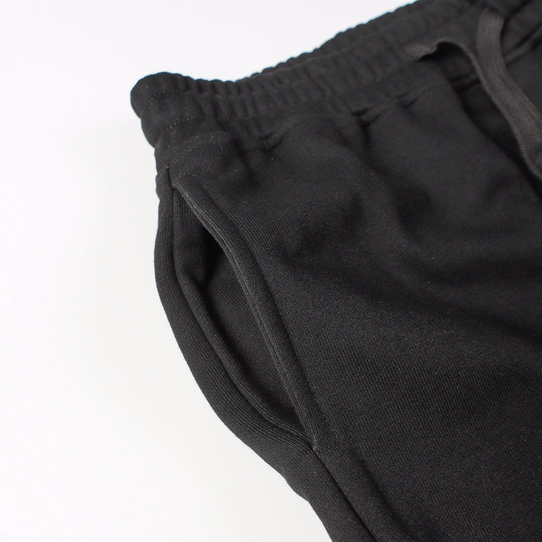 Stone Island black jogger pants close-up of side seam and curved hem