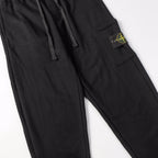 Stone Island black jogger pants with front drawstring and logo patch detail