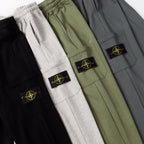 Set of drawstring cargo joggers in black, white, and olive with side patches