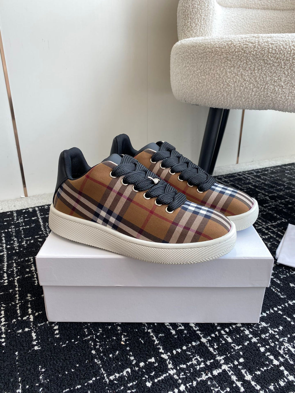 Burberry low-top sneakers with plaid side panels, black laces, and white sole