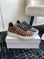 Burberry low-top sneakers with plaid side panels, black laces, and white sole