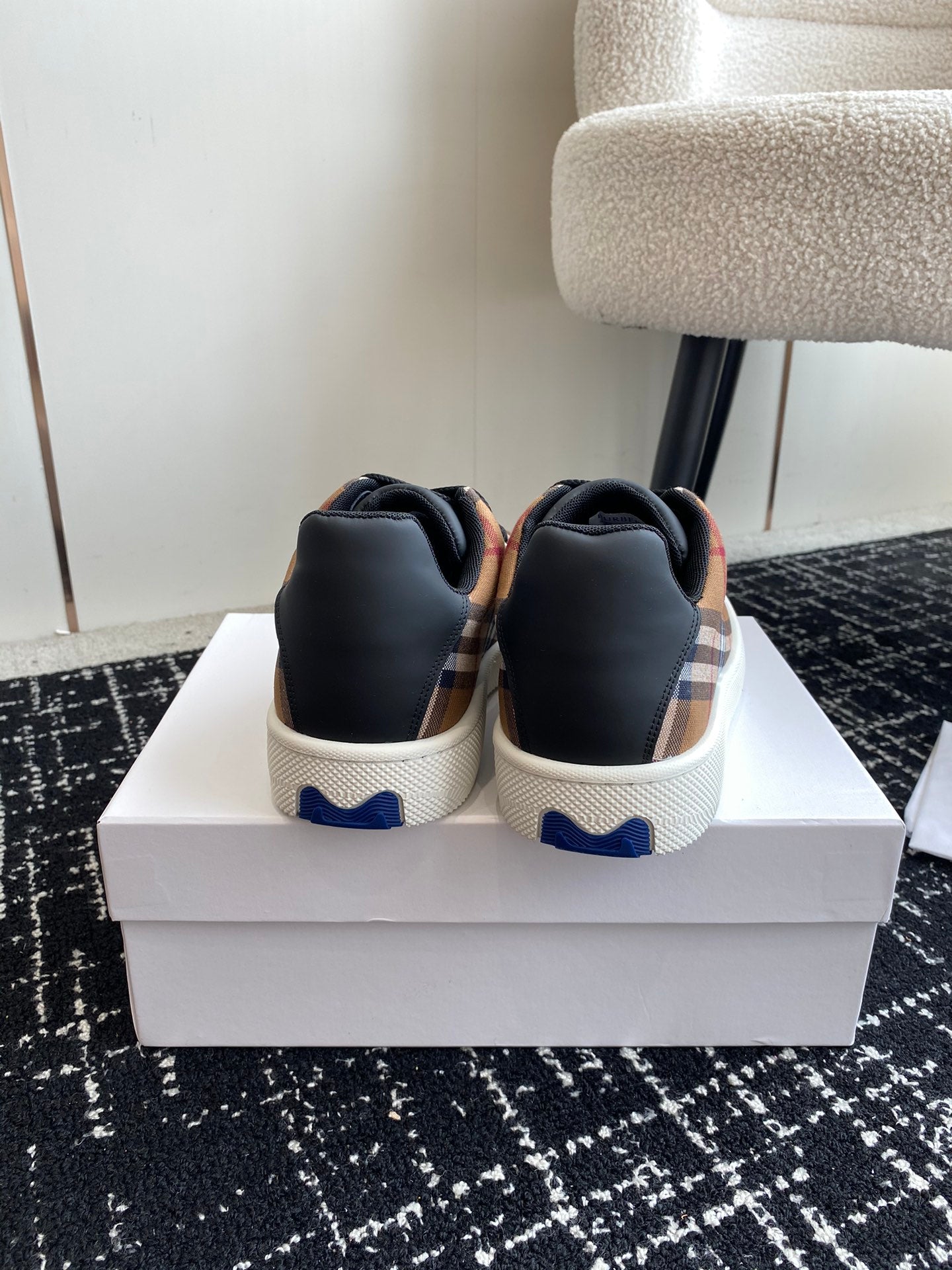 Burberry low-top sneakers, back view with navy heel tabs and white soles