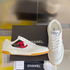 White low-top sneakers with red CC logo on side and lace-up front, gum sole