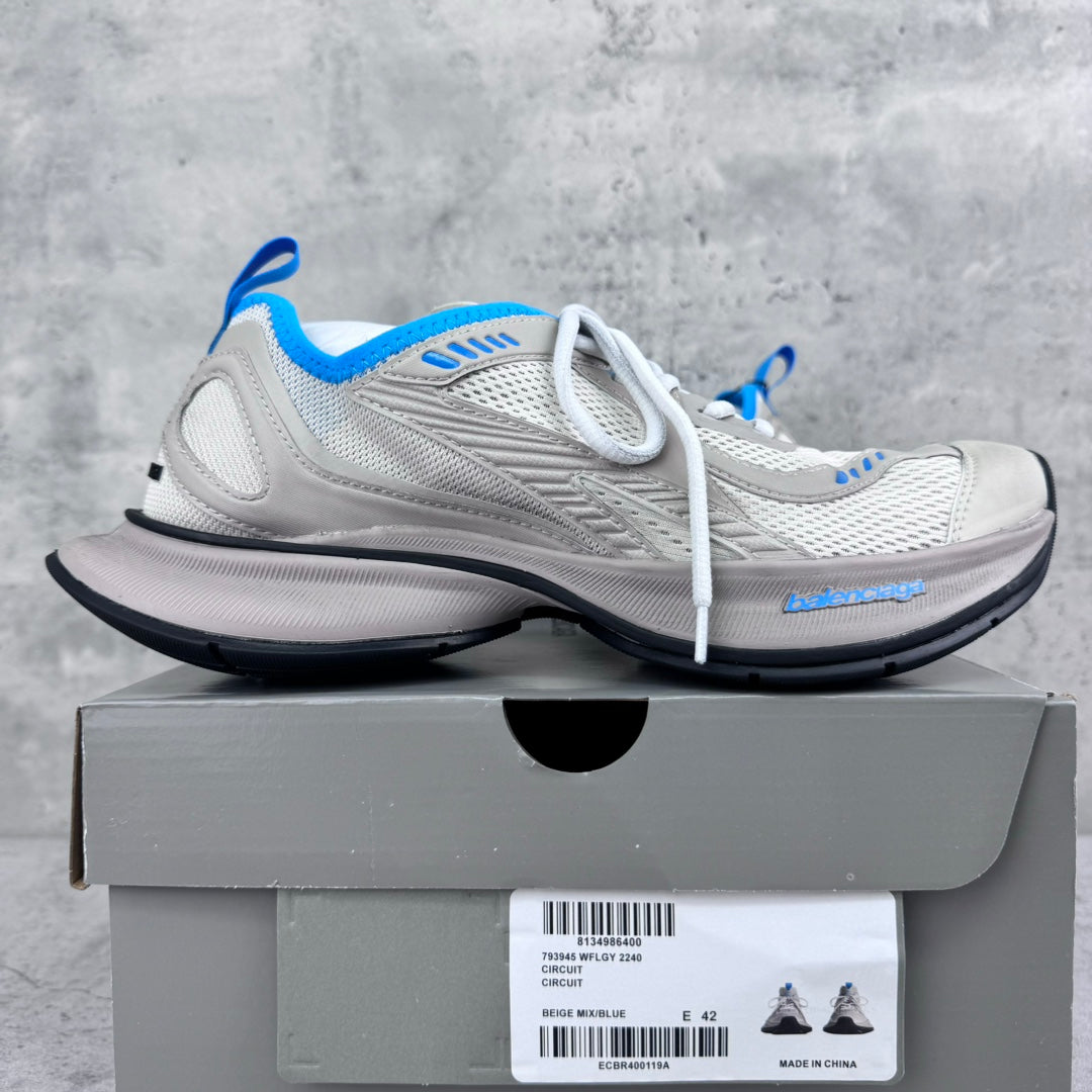 White lace-up sneakers with blue accents, mesh upper, and thick black sole.