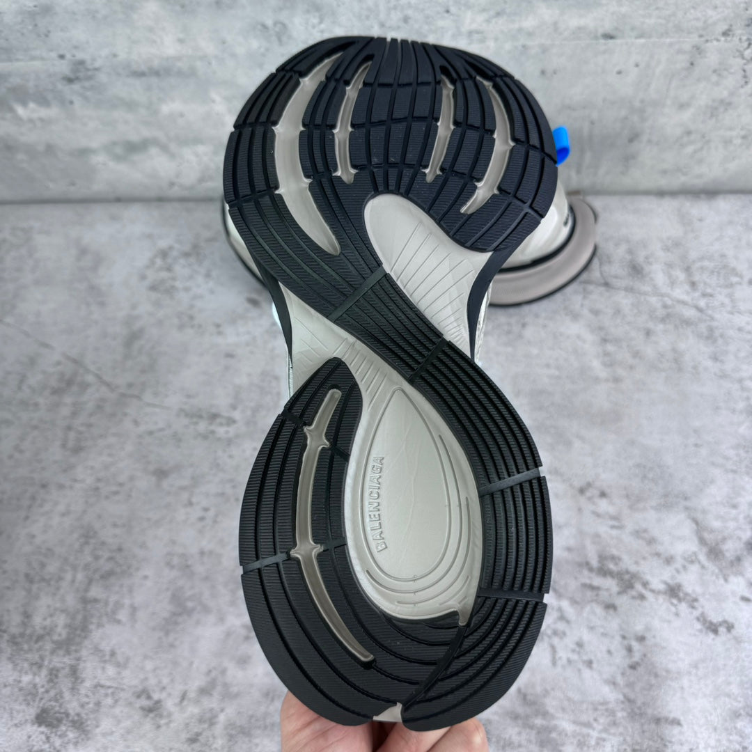 Dual-tone sneaker outsole with tread, dark edges, and light center.