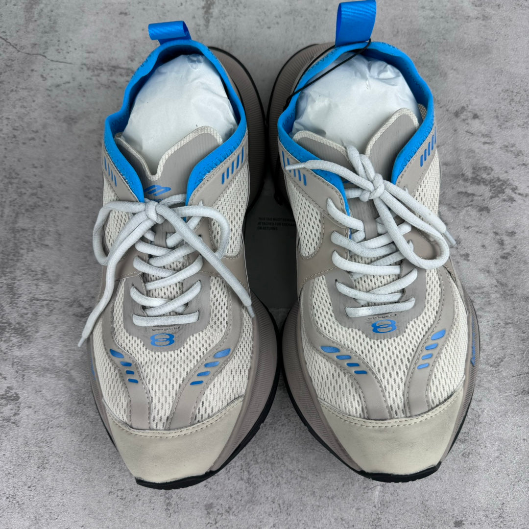 Pair of white lace-up sneakers with blue heel loops and thick black soles.