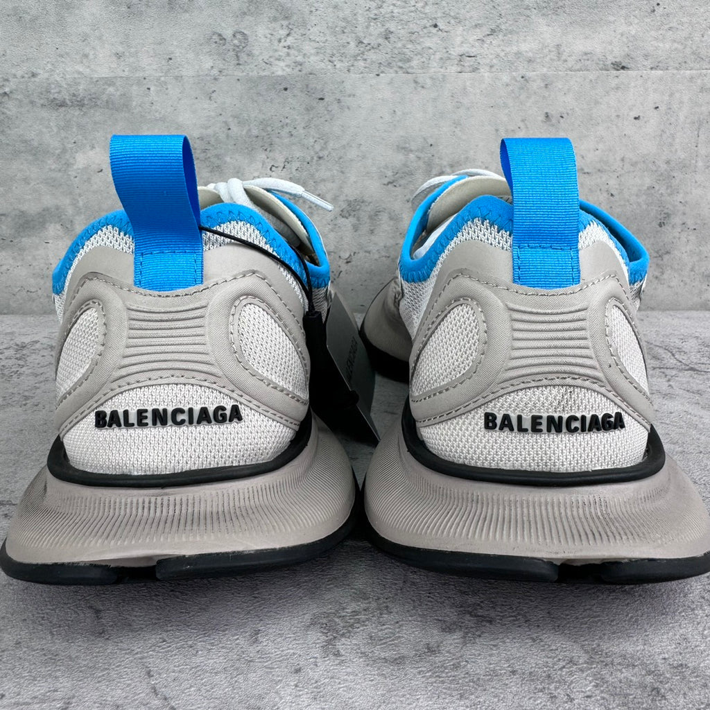White sneakers with blue heel loops and BALENCIAGA logo on the back.