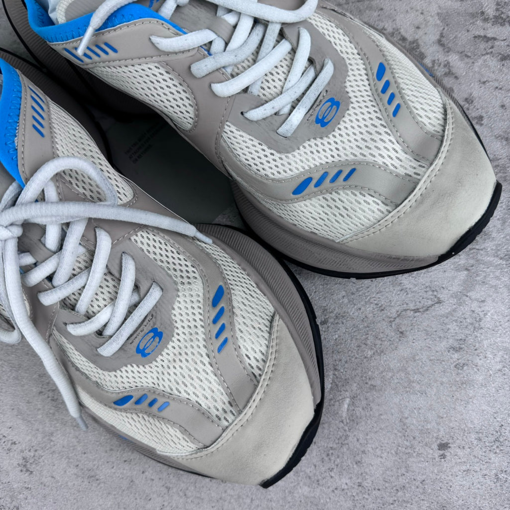 White and blue lace-up sneakers with mesh uppers and cushioned midsole.