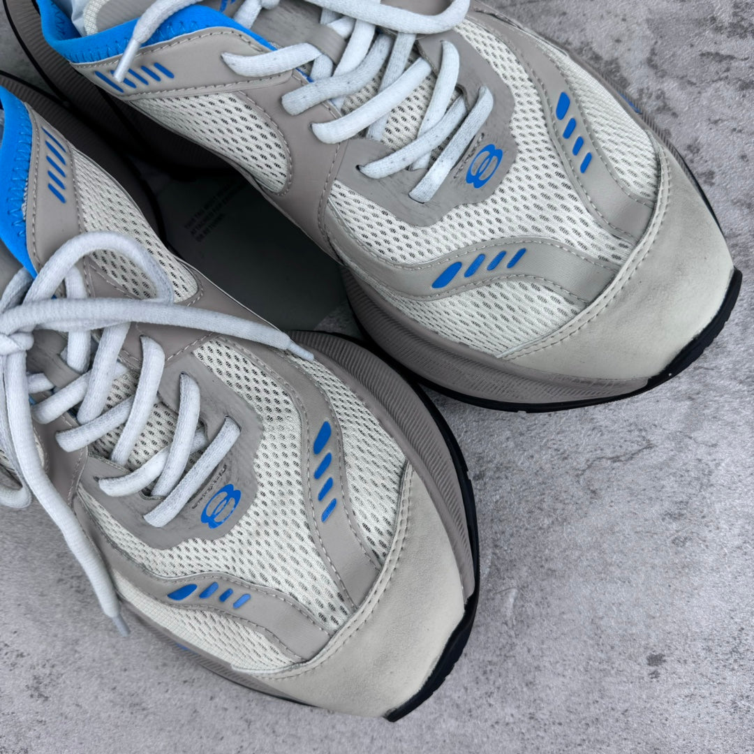 White and blue lace-up sneakers with mesh uppers and cushioned midsole.