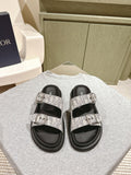 Dior slide sandals with light gray monogram straps and black rubber soles