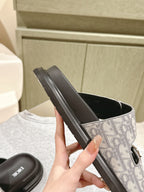 Dior slide sandals side view, monogram upper over black sole