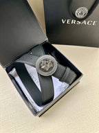 Dark textured leather belt with large round silver Medusa buckle