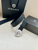Dark leather belt with round silver Medusa buckle and keeper strap