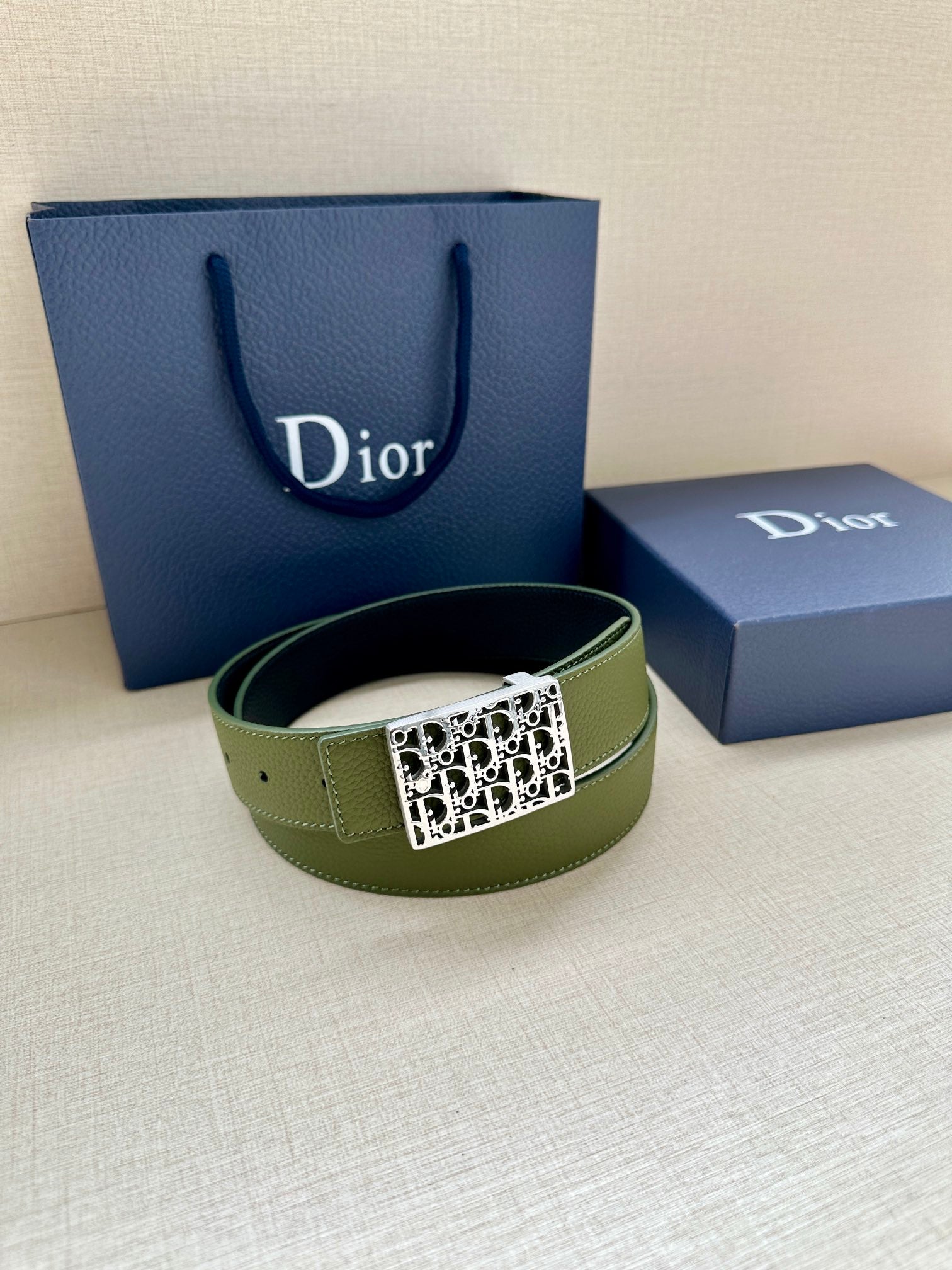 Dior belt on stand: olive green leather with gold square Dior monogram buckle