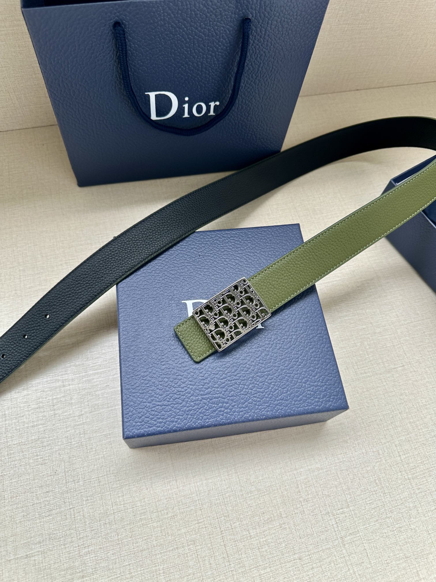 Dior belt diagonal view: olive strap with gold-tone Dior monogram square buckle