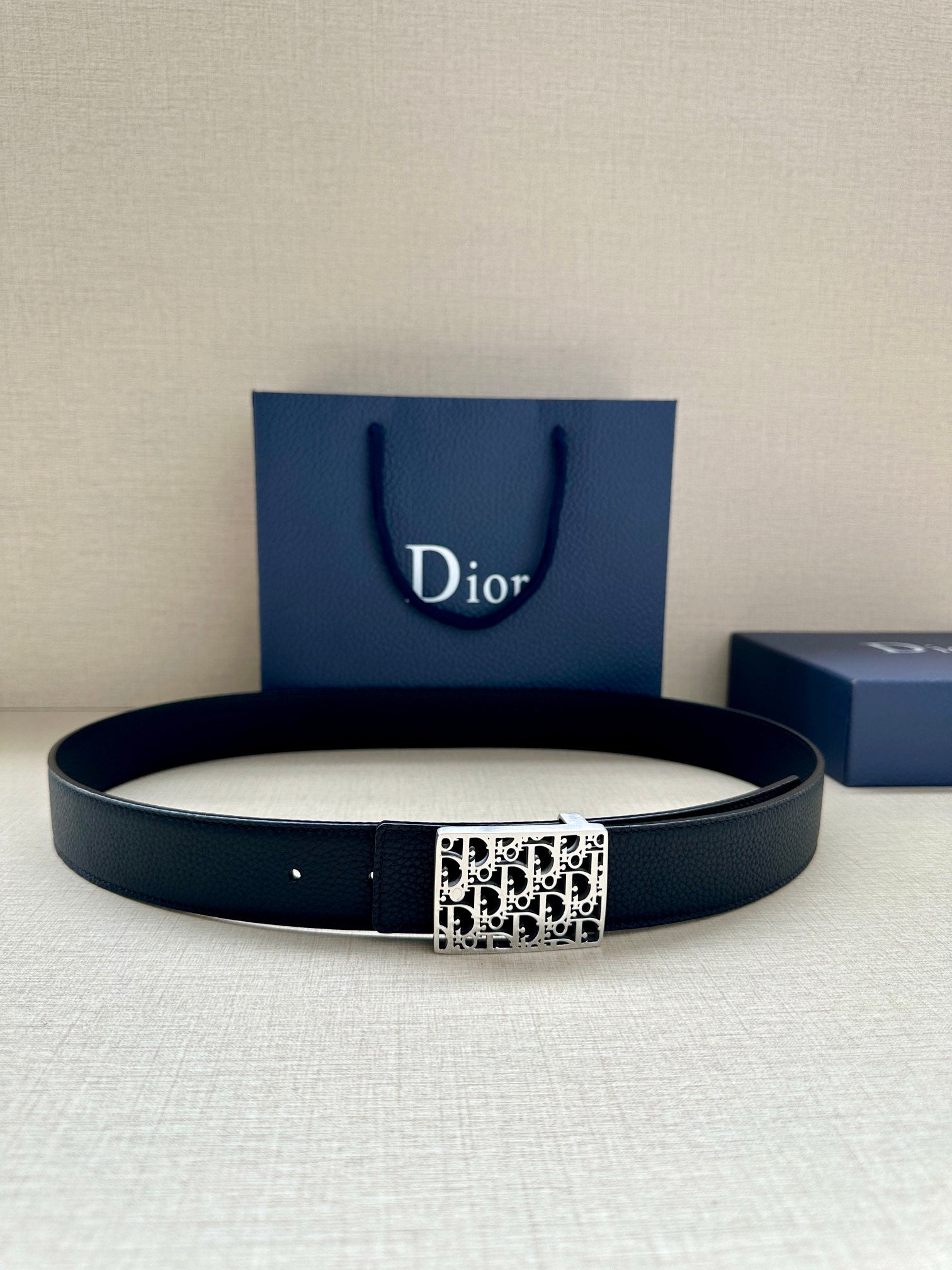 Dior leather belt in dark finish with square monogram buckle.