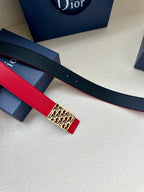 Dior belt detail: red strap over navy backing with rectangular logo buckle.