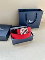 Dior belt in red leather with patterned buckle and dual-tone strap.