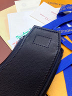 Louis Vuitton bag close-up of dark leather patch and zipper seam