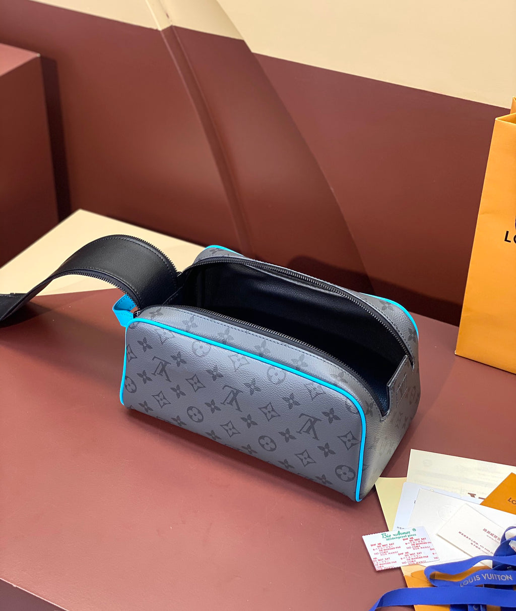Louis Vuitton toiletry bag with monogram print, open top showing black interior
