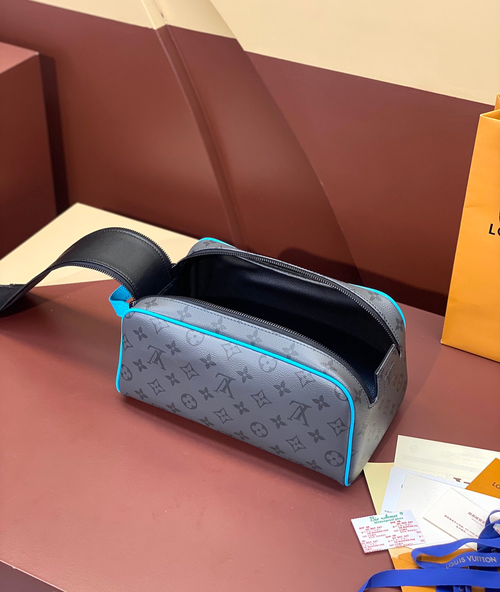 Louis Vuitton toiletry bag with monogram print, open top showing black interior