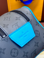 Louis Vuitton monogram bag close-up with blue leather logo label and zipper