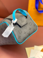 Louis Vuitton mini bag with monogram print, blue strap handle and hanging tag