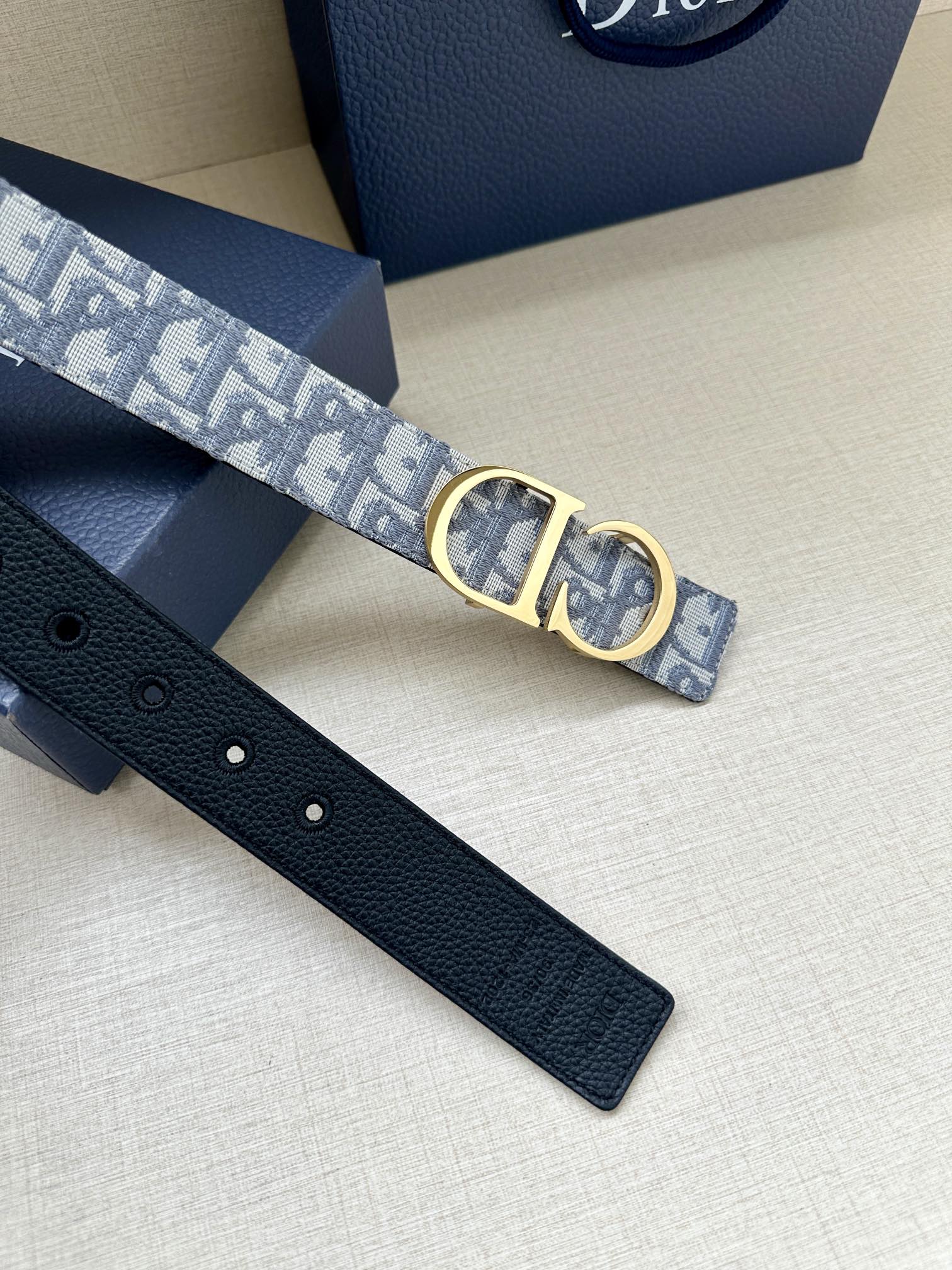 Dior belt with gold CD buckle and light-blue logo strap, black leather holes