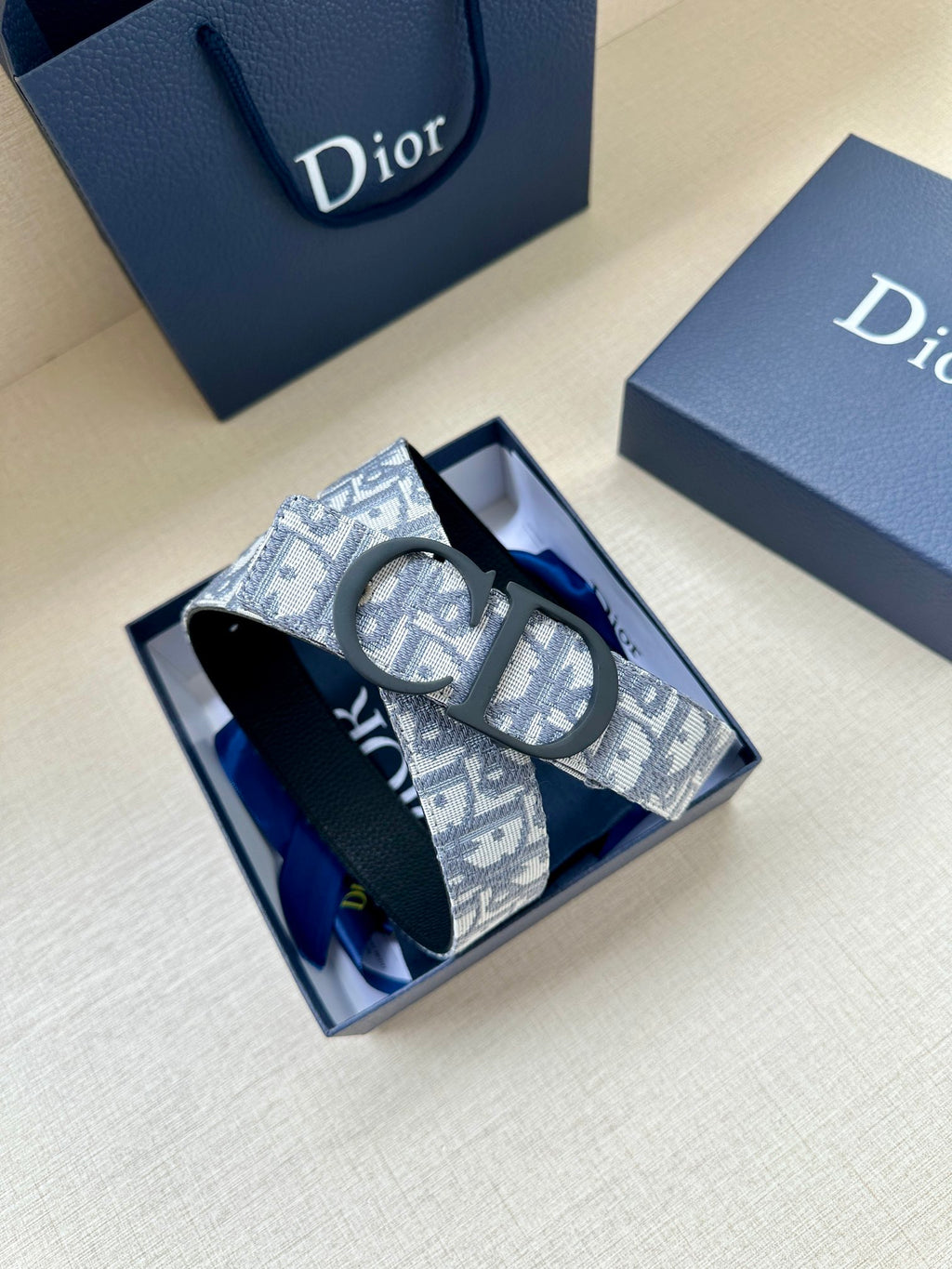Dior belt with blue monogram patterned strap and dark buckle