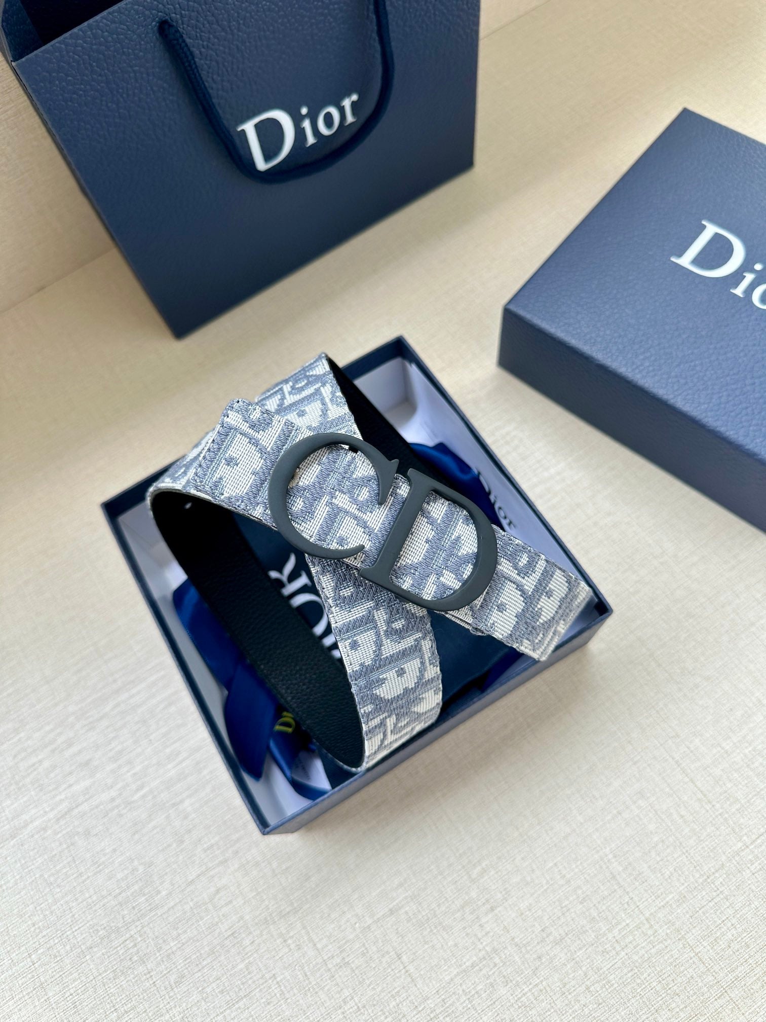 Dior belt with blue monogram patterned strap and dark buckle