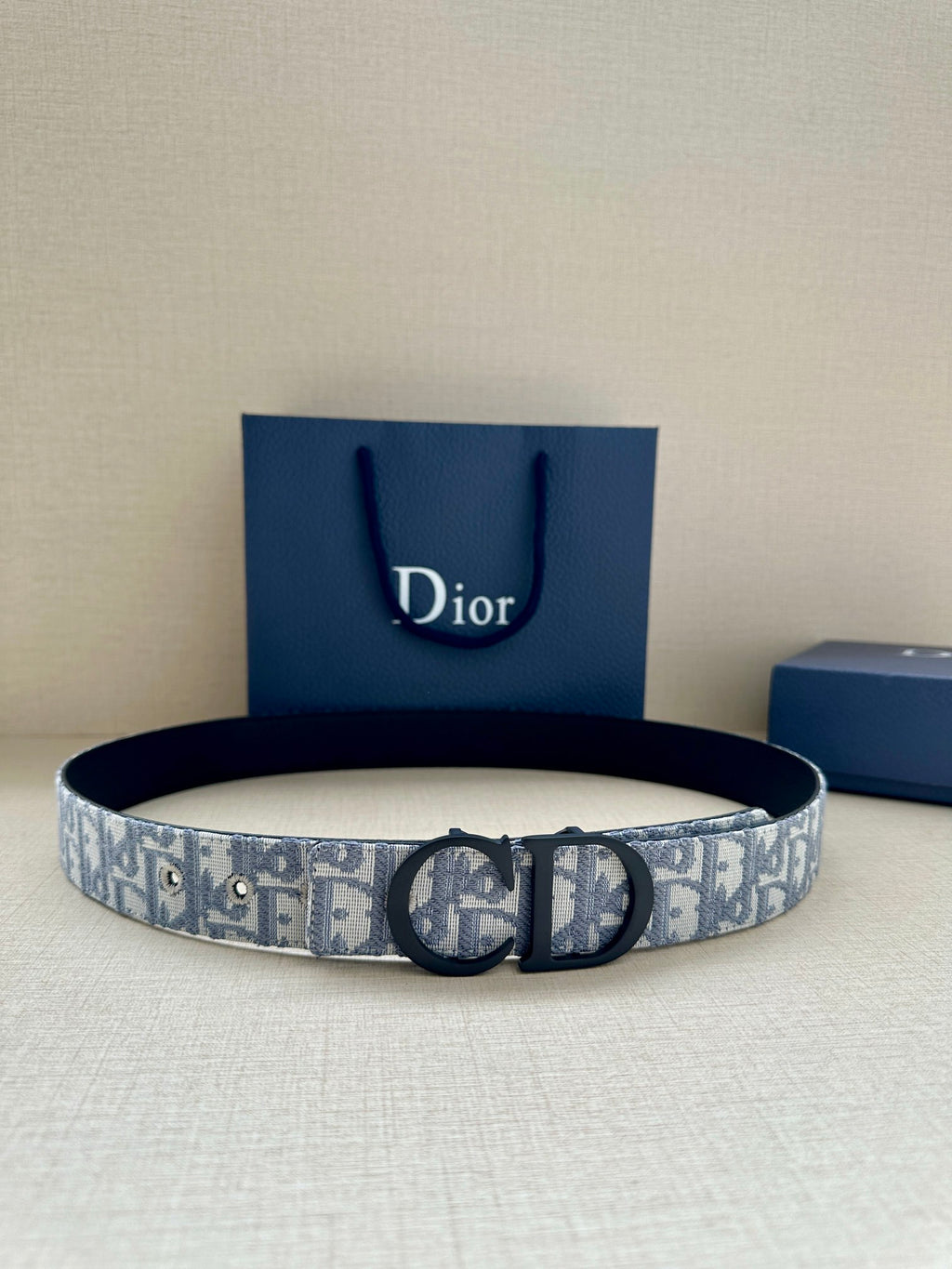Dior belt with blue-and-white monogram strap and dark metal buckle