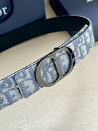 Dior belt close-up: patterned canvas strap with oval silver buckle detail