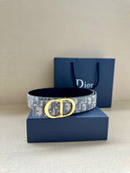 Dior monogram belt with light blue-gray canvas strap and gold-tone buckle