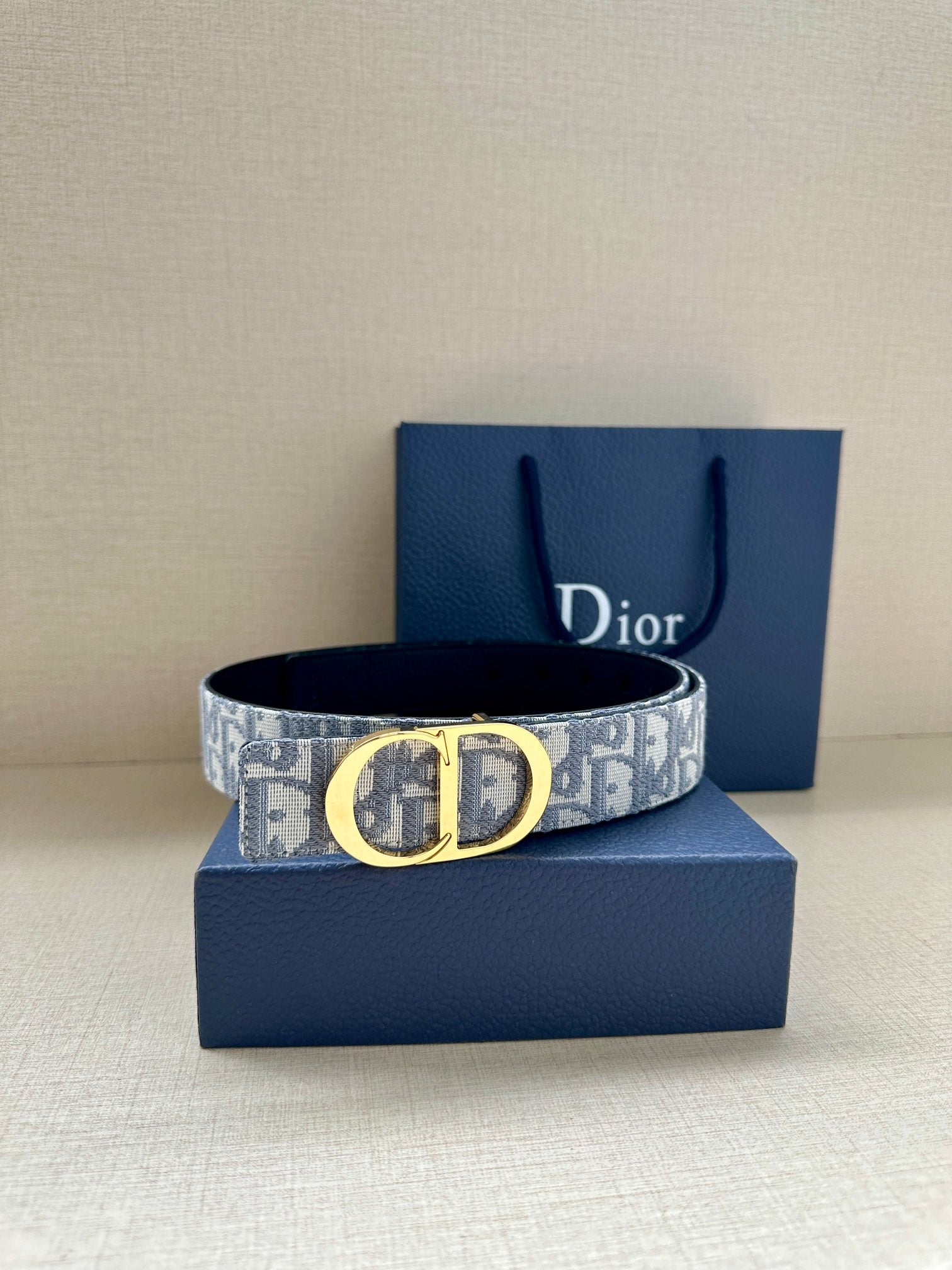 Dior monogram belt with light blue-gray canvas strap and gold-tone buckle