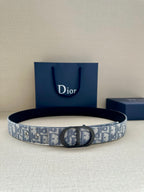 Monogram belt with dark buckle, blue-and-gray patterned strap