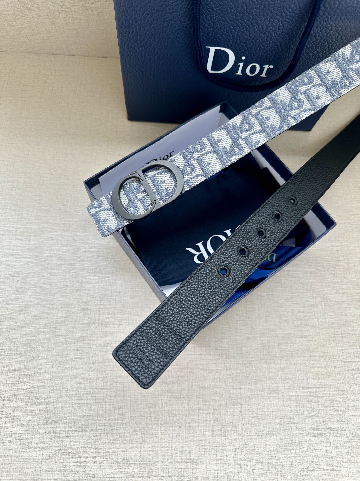 Monogram belt with reversible dark leather strap, blue-gray patterned strap shown open