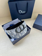 Monogram belt in box with patterned strap, dark leather underside, oval buckle