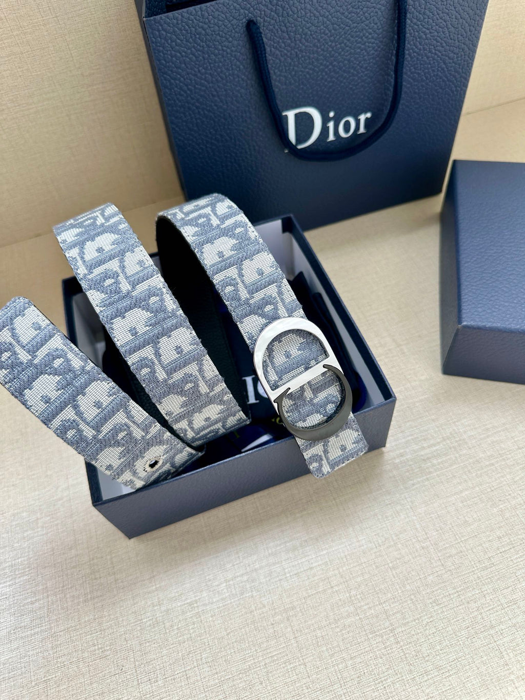 Two light blue logo-print belt straps with silver buckles