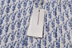 Dior shorts with hanging white size tag on blue print