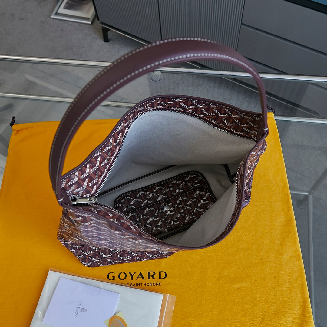 Burgundy patterned Goyard tote bag interior with zipper pocket and top handle.