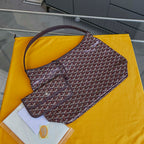Burgundy patterned Goyard hobo bag with curved handle and open top.