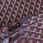 Burgundy Goyard patterned clasp and strap detail on mini pouch.