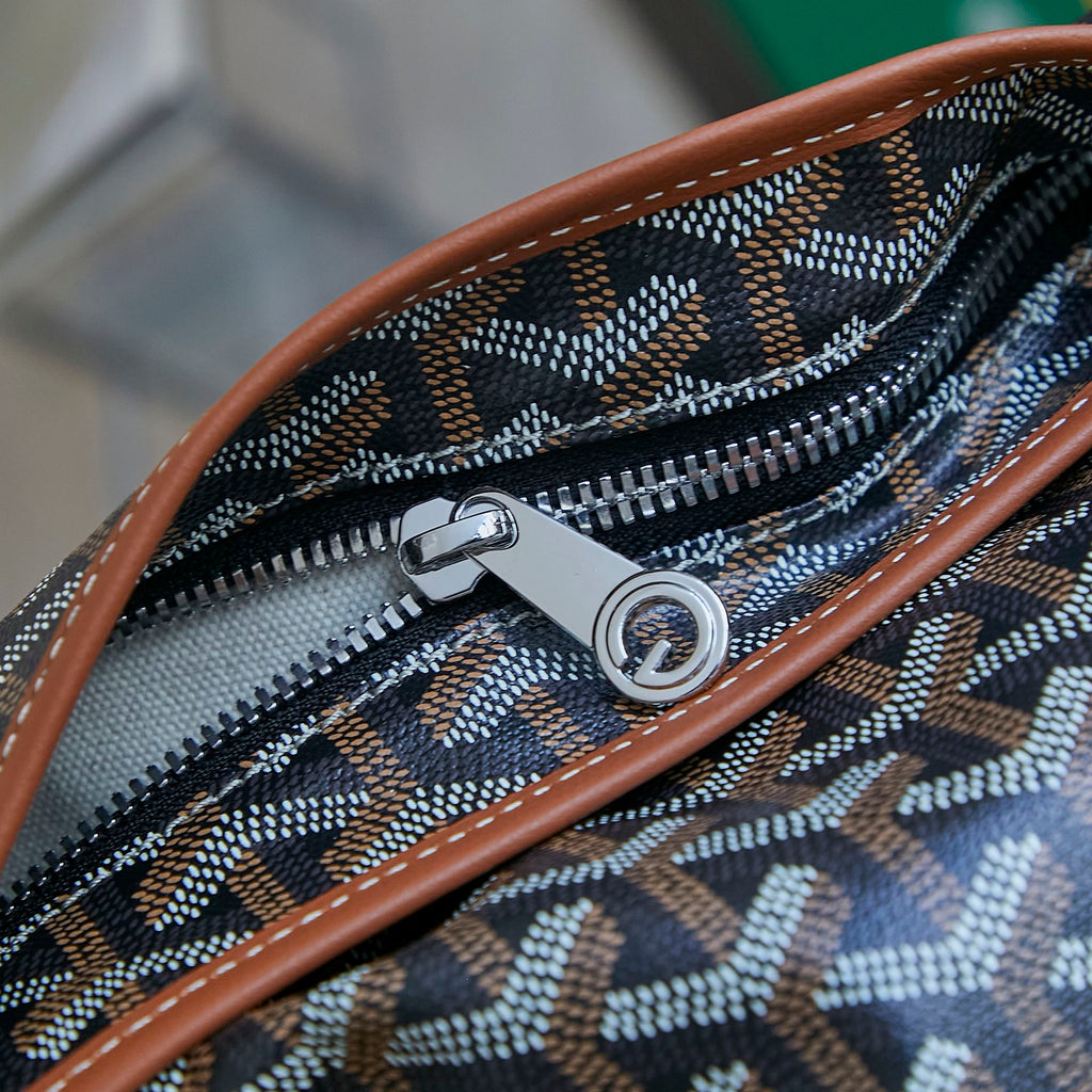 Monogram canvas bag zipper with metal pull and brown leather edging