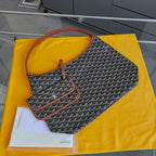 Monogram canvas shoulder bag with brown leather strap and zip-top opening
