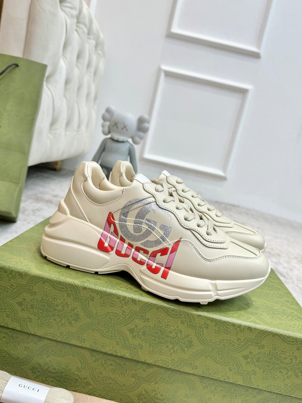 Gucci unisex off-white sneakers with red and gray logo graphic on the side