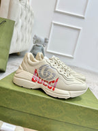 Gucci unisex off-white sneakers with red and gray logo graphic on the side