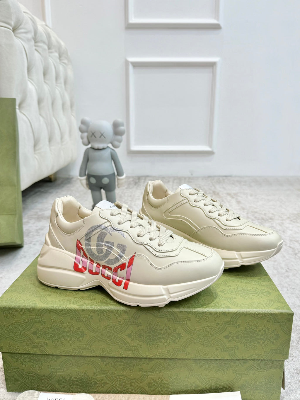 Gucci unisex off-white sneakers, three-quarter view, lace-up with side logo graphic