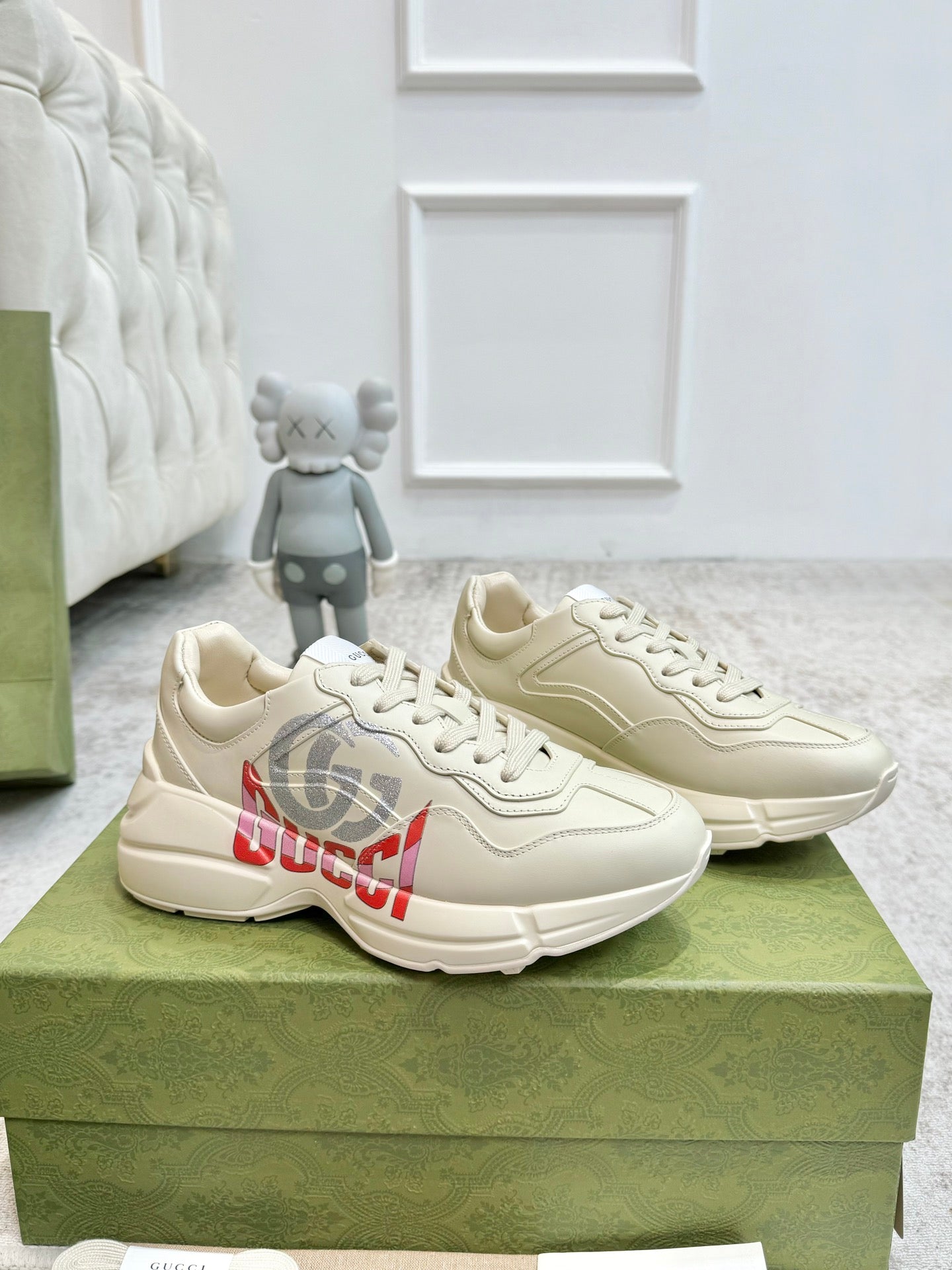 Gucci unisex off-white sneakers, three-quarter view, lace-up with side logo graphic