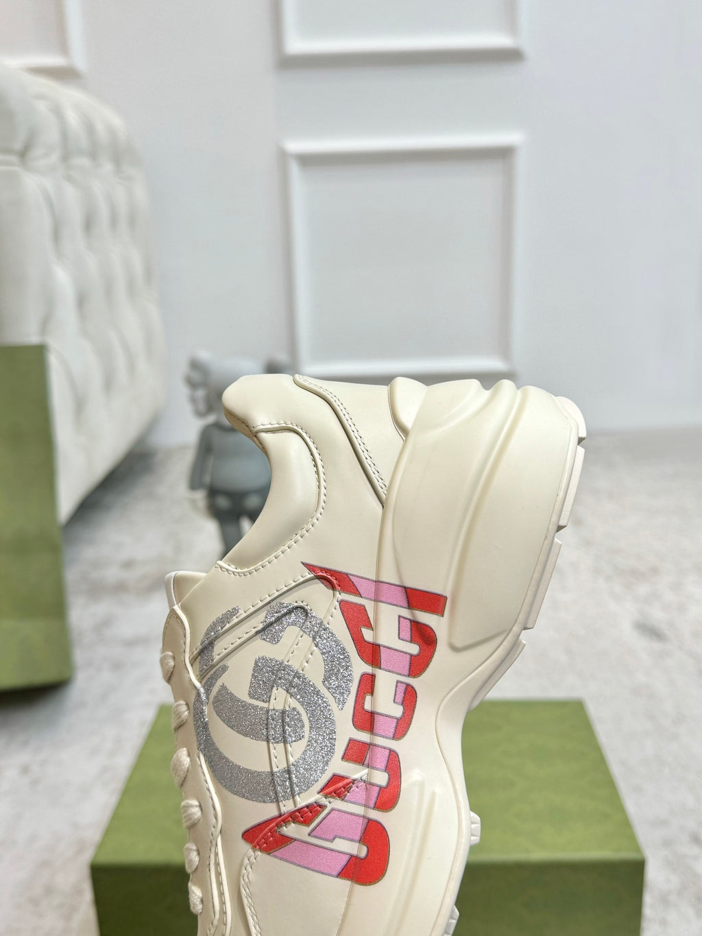Gucci unisex off-white sneaker with red and gray logo on the quarter panel