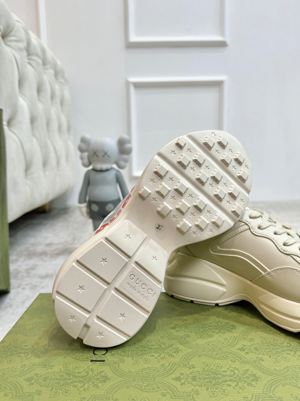 Gucci unisex off-white sneaker outsole view with tread and branding on the heel